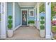 Inviting front porch featuring decorative plants and a stylish door, enhancing the home's curb appeal at 2710 Mcfadden Way, Johns Island, SC 29455