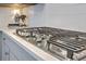Close-up of a gas cooktop with white subway tile backsplash and modern cabinetry at 2710 Mcfadden Way, Johns Island, SC 29455
