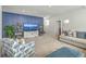 Comfortable living room featuring gold shelving, a large TV, and bright light, offering a unique design at 2710 Mcfadden Way, Johns Island, SC 29455