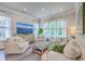 Inviting living room with comfortable seating, large windows, and a stylish TV console at 2710 Mcfadden Way, Johns Island, SC 29455