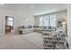 Spacious living room with a sectional sofa, patterned chair, and bright lighting, creating a cozy ambiance at 2710 Mcfadden Way, Johns Island, SC 29455