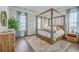 Elegantly designed main bedroom featuring a four-poster bed, stylish furnishings, and ample natural light at 2710 Mcfadden Way, Johns Island, SC 29455