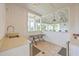 Bright outdoor kitchen featuring white cabinetry, stainless steel sink, and pass-through window to the outdoor pavilion at 2710 Mcfadden Way, Johns Island, SC 29455