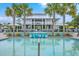 Resort-style pool with palm trees, lounge chairs, and a spacious pavilion for relaxation and entertainment at 2710 Mcfadden Way, Johns Island, SC 29455