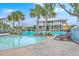 Community pool with ample seating, palm trees, and a cabana for relaxing at 2710 Mcfadden Way, Johns Island, SC 29455