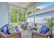 Comfortable screened porch featuring wicker furniture, patterned cushions, and a view of the backyard at 2710 Mcfadden Way, Johns Island, SC 29455