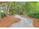 Scenic community walking path winding through mature trees, offering a peaceful outdoor experience at 2710 Mcfadden Way, Johns Island, SC 29455