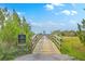 Inviting wooden bridge entrance to a Stonoview community nature trail with a community sign at 2710 Mcfadden Way, Johns Island, SC 29455