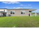 Spacious backyard with green grass and a covered patio provides a relaxing outdoor retreat at 286 W Bradford Pointe Dr, Summerville, SC 29486