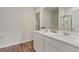 Bright bathroom featuring double sinks, a large mirror, modern fixtures, and wood-look floors at 286 W Bradford Pointe Dr, Summerville, SC 29486