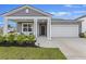 Charming single-Gathering home featuring a covered porch, attached garage, and a well-manicured lawn at 286 W Bradford Pointe Dr, Summerville, SC 29486