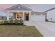 Charming single-Gathering home featuring a covered porch, attached garage, and a well-manicured lawn at 286 W Bradford Pointe Dr, Summerville, SC 29486