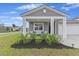 Charming single-Gathering home featuring a covered porch, attached garage, and a well-manicured lawn at 286 W Bradford Pointe Dr, Summerville, SC 29486