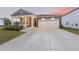 Charming single-Gathering home featuring a covered porch, attached garage, and a well-manicured lawn at 286 W Bradford Pointe Dr, Summerville, SC 29486