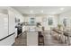 Well-lit kitchen offers modern appliances, white cabinets, granite countertops, and a dining area with a large window at 286 W Bradford Pointe Dr, Summerville, SC 29486