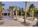 Outdoor seating and dining area with palm trees, perfect for enjoying the community at 286 W Bradford Pointe Dr, Summerville, SC 29486