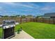 Well-maintained backyard featuring a concrete patio and vibrant green grass, perfect for entertaining and relaxation at 302 Fiddleback Dr, Summerville, SC 29486