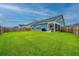 Spacious backyard with a wooden fence, lush green lawn, and grilling area for relaxed outdoor gatherings at 302 Fiddleback Dr, Summerville, SC 29486