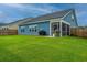 Expansive fenced backyard with lush green lawn, screened porch and grilling area for outdoor enjoyment at 302 Fiddleback Dr, Summerville, SC 29486