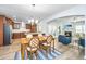 Open-concept dining area boasts a modern chandelier, and seamlessly connects to the kitchen and living room at 302 Fiddleback Dr, Summerville, SC 29486