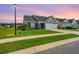 Beautiful home with manicured lawn and two-car garage is seen at sunset at 302 Fiddleback Dr, Summerville, SC 29486