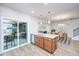 Bright kitchen features an island with stainless steel sink and an open floor plan at 302 Fiddleback Dr, Summerville, SC 29486