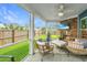 Spacious screened patio boasts outdoor seating, a fan, and views of the backyard and neighborhood at 302 Fiddleback Dr, Summerville, SC 29486