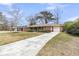 Inviting single story brick home with a long driveway and attached garage, nestled in a serene landscape at 303 Gippy Dr, Summerville, SC 29486