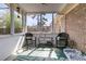 Inviting sunroom featuring brick accents, wicker furniture, and views of the backyard at 303 Gippy Dr, Summerville, SC 29486