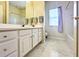Bathroom featuring double vanity with ample storage, large mirror, and neutral finishes at 3104 Mariners Way, Moncks Corner, SC 29461