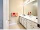 Bathroom featuring double vanity with ample storage, large mirror, and neutral finishes at 3104 Mariners Way, Moncks Corner, SC 29461