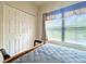 Bedroom featuring a large window with blinds and a closet with double doors at 3104 Mariners Way, Moncks Corner, SC 29461