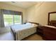 Comfortable bedroom features a large window, wooden bed frame, and dark wood furnishings at 3104 Mariners Way, Moncks Corner, SC 29461