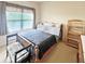 Comfortable bedroom features a large window, wooden bed frame, and upholstered chair at 3104 Mariners Way, Moncks Corner, SC 29461