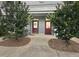 Inviting entrance with cozy bench and mature trees enhancing the charm of the home at 3104 Mariners Way, Moncks Corner, SC 29461