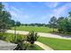 Landscaped community view with lush green space and beautiful trees in a Gathering-friendly neighborhood at 3104 Mariners Way, Moncks Corner, SC 29461