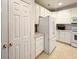 Well-lit kitchen featuring white cabinets, modern appliances, and convenient storage solutions at 3104 Mariners Way, Moncks Corner, SC 29461
