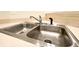 Modern stainless steel kitchen sink with running water, blending functionality and style at 3104 Mariners Way, Moncks Corner, SC 29461