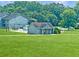 Community pool area with a small building, surrounded by a green lawn and trees at 3104 Mariners Way, Moncks Corner, SC 29461