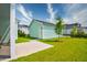 View of the backyard featuring a shed, green grass, landscaping, and blue skies perfect for outdoor enjoyment at 312 Clearpath Dr, Summerville, SC 29486