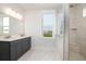 Well-lit bathroom with double vanity, marble shower, and a large window overlooking the neighborhood at 312 Clearpath Dr, Summerville, SC 29486
