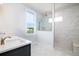 Bright bathroom with double vanity, marble walk-in shower, and a window with a view at 312 Clearpath Dr, Summerville, SC 29486