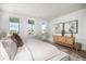 Bright bedroom with white walls, plush bedding, a stylish wood dresser, and view of the backyard at 312 Clearpath Dr, Summerville, SC 29486