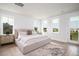 Inviting bedroom with natural light, a cozy bed, side tables, and view of the pond at 312 Clearpath Dr, Summerville, SC 29486