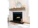 Close-up of a modern fireplace with a wooden mantle and decorative accents at 312 Clearpath Dr, Summerville, SC 29486