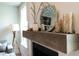 Stylish fireplace mantel with elegant decor, mirror, and decorative vases at 312 Clearpath Dr, Summerville, SC 29486