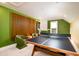 Bright game room with ping pong table, dart board, colorful decor and fun, green walls for hours of Gathering entertainment at 312 Clearpath Dr, Summerville, SC 29486