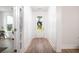 Bright hallway with white walls and wood floors, leading to the front door at 312 Clearpath Dr, Summerville, SC 29486