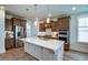 Bright kitchen showcasing a large island with marble countertops, stainless steel appliances and plenty of storage space at 312 Clearpath Dr, Summerville, SC 29486