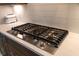 Modern kitchen cooktop with sleek stainless steel finish, integrated into a white countertop and light backsplash at 312 Clearpath Dr, Summerville, SC 29486